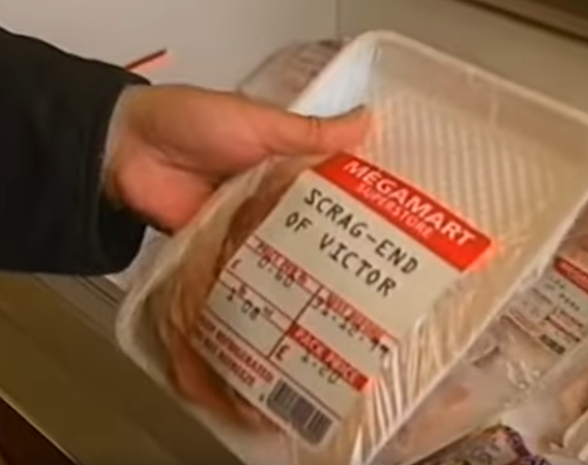 SCREENCAP: Shrink-wrapped polystyrene tray of meat off-cuts, labelled 'Scrag-End of Victor'.